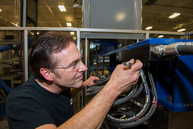 a man working on a machine and fixing it
